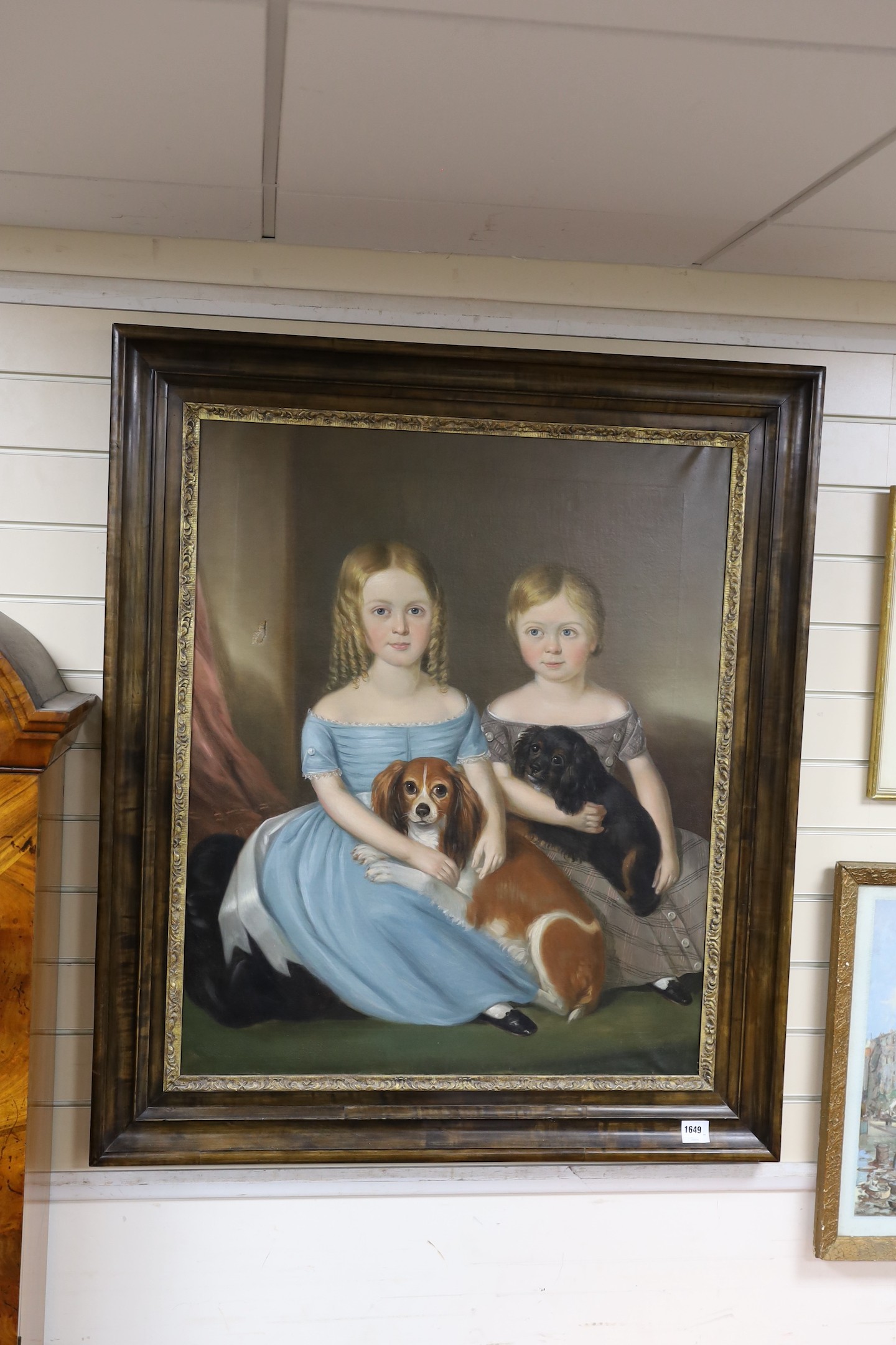 Mid 19th century English School, Portrait of two children seated with their King Charles Spaniels, oil on canvas, 91 x 74cm